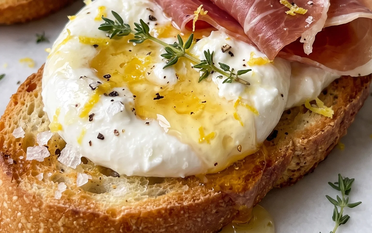 Beef Prosciutto Crostini with Burrata and Lemon Honey Drizzle